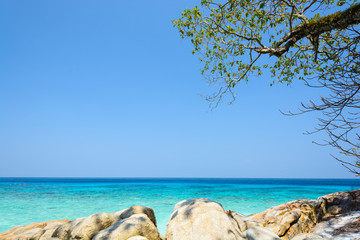 Sea and sky with trees and rocks on beach at Tachai island, Southern Thailand