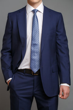 man in blue tuxedo with light blue tie