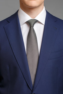 man in blue tuxedo with grey tie