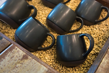 Coffee cups on coffee beans