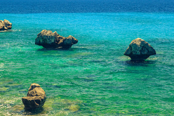 The rocky coast overlooking the turquoise blue sea in warm summer day. Greece. Chalkidki

