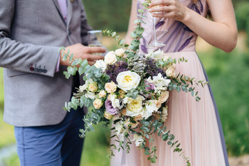 bride and groom holding on to flower bouquet