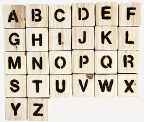 Wood burned alphabet blocks. Isolated.
