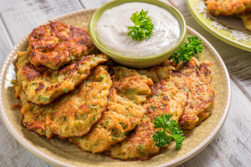 Obraz premium Vegetable fritters with potato, carrot, zucchini served with Ranch sauce.