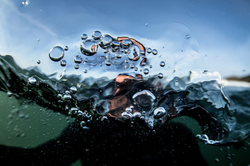 View of water bubbles and blurred figure from underneath 