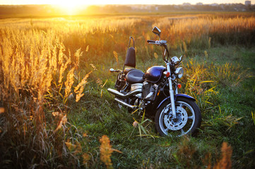 Motorcycle outdoors at sunset in summer.