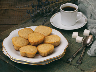 The composition of the gluten-free rice-banana muffin, a cup of coffee and a bouquet of lavender. Romantic breakfast. Vintage photo.