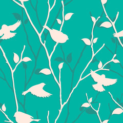 

Seamless blue pattern with birds and twigs. Vector spring background with bird silhouettes