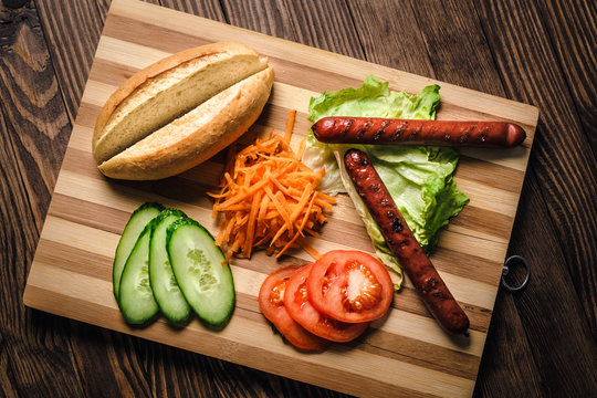 Cooking tasty hot dog with Bavarian sausages