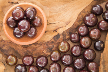 Berry Jaboticaba on wooden table (Plinia cauliflora)