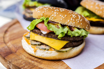 Burgers on a round wooden board