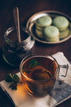 Steaming cup of tea on dark background