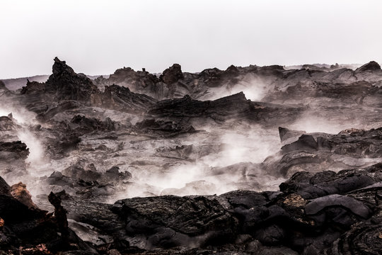 Steaming lava pieces under light rain