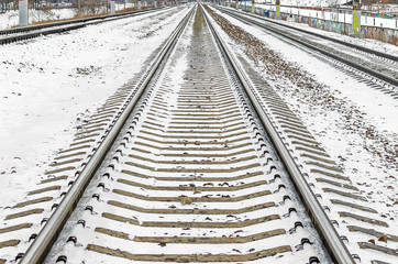 Railway rails sleepers away snow in winter
