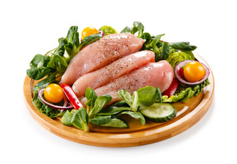 Raw chicken breasts on cutting board 