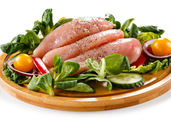 Raw chicken breasts on cutting board 