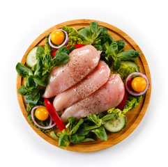 Raw chicken breasts on cutting board 