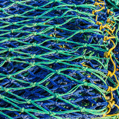 Detail image of nylon, blue and turquoise fishing net.
