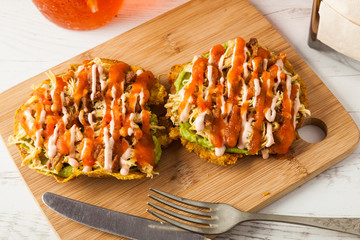 Colombian food: patacones with guacamole and meat.