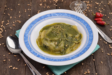 dish of ravioli with basil and pine nuts
