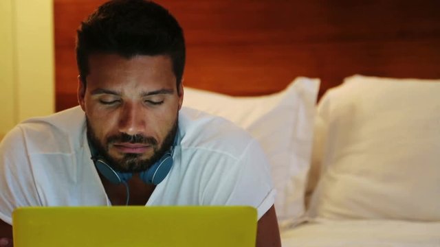 Man In Bed With Yellow Laptop