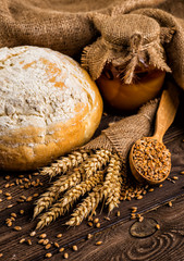 Freshly baked traditional bread with honey on a wooden table