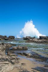 Fototapeta na wymiar Seascape: beach, rocks and blue sky