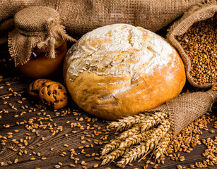 Freshly baked traditional bread with honey on a wooden table