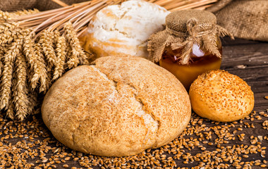 Assortment of baked bread on wooden table background