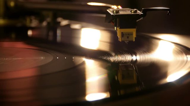 Close up at the needle on turntable.