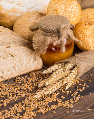 Assortment of baked bread on wooden table background