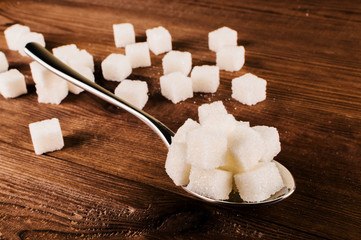 Diabetes. A lot of sugar cubes in spoon