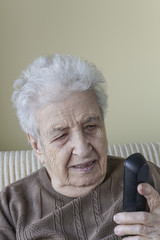 senior woman looking to phone