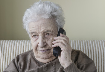 Thoughtful senior woman on phone