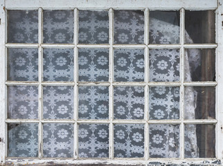 Old window in one of the village houses, many squares style