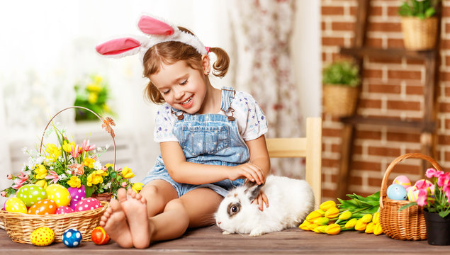 happy easter! happy funny child girl playing with bunny