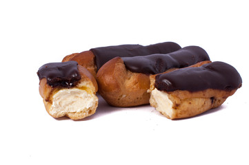 Cake eclair custard is broken in half isolated on white