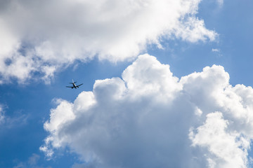 airplane in the blue sky and clouds.