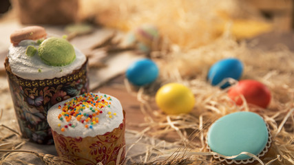 Festive Easter on the tablecloth. Colored Easter eggs laid near the cake