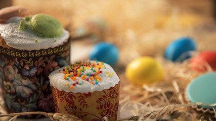 Festive Easter on the tablecloth. Colored Easter eggs laid near the cake