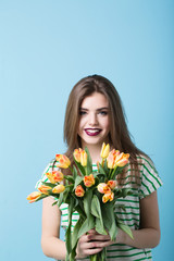 Beautiful young woman with tulips.