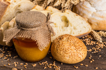 Assortment of baked bread on wooden table background