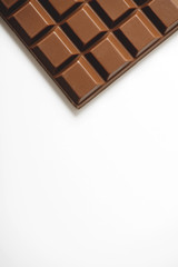 Tablet with chocolate milk on white background. Copy-space. Isolated.
