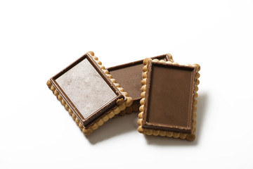 Various chocolate covered cookies on white background. Isolated. Horizontal shoot.