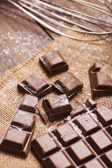Chocolate chip with sugar icing next to cookware. Vertical shoot.