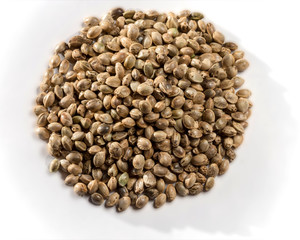 Heap of hemp seeds isolated on white background.