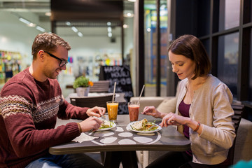 happy couple eating dinner at vegan restaurant