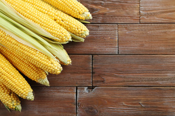 Sweet corns on a brown wooden table
