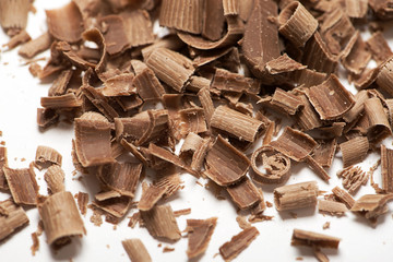 Close-up of chocolate chips on white background. Isolated.