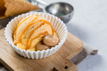 Caramel ice cream in white bowl